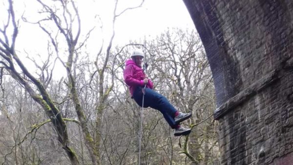 Person abseiling over viaduct