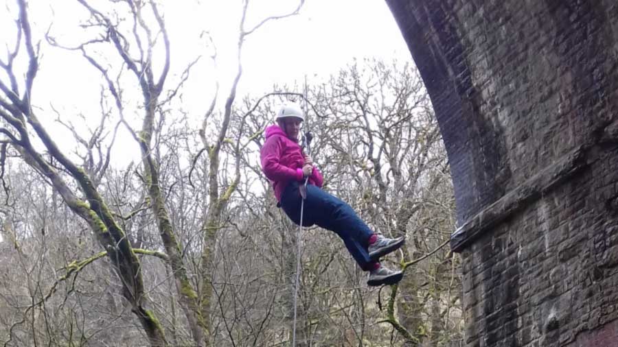 Person abseiling over viaduct